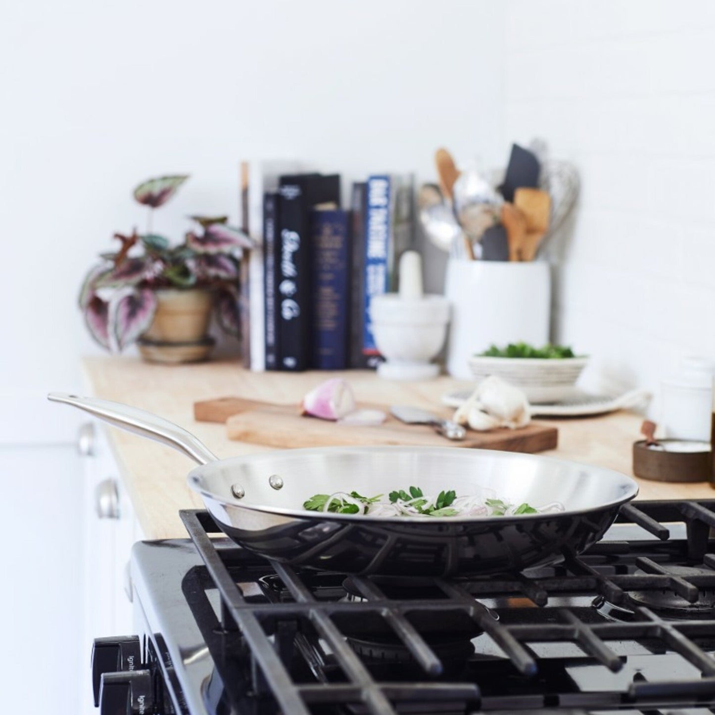 Heritage Steel Titanium Series 12-inch fry pan with lid, showcasing durable cookware with a stainless steel handle and glass lid.