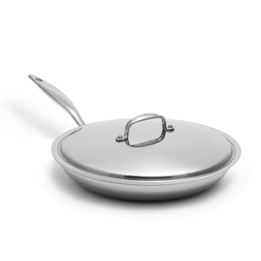 Heritage Steel Titanium Series 12-inch fry pan with lid, showcasing polished stainless steel cookware on a kitchen countertop