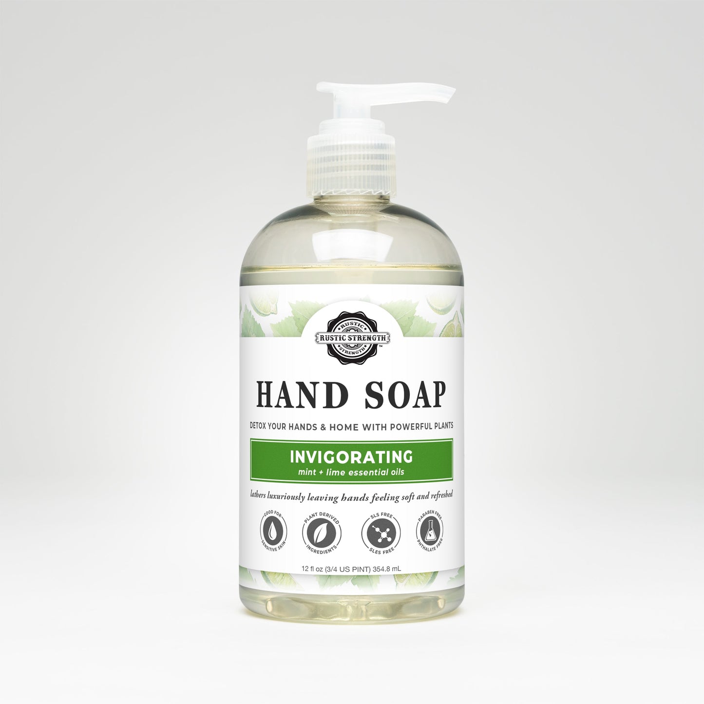 A clear plastic pump bottle of Rustic Strength Hand Soap | Invigorating, featuring a white label. Biodegradable and infused with peppermint lime essential oil, it claims to detox hands and home using plant-based ingredients.