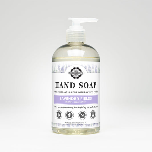 Rustic Strength Hand Soap | Lavender Fields comes in a clear plastic pump bottle with a white label and lavender accents, highlighting its essential oils content. Its biodegradable and sulfate-free.