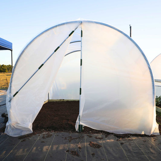 Bootstrap Farmer 10x12 backyard greenhouse kit with zipper door and roll-up sides, ideal for gardening and plant protection.