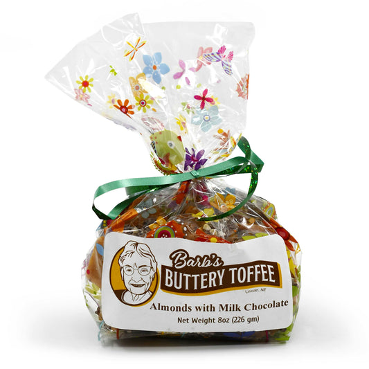 Homemade milk chocolate toffee with almonds in an 8 oz package from Barb's Buttery Toffee, featuring nut options and a crunchy texture.