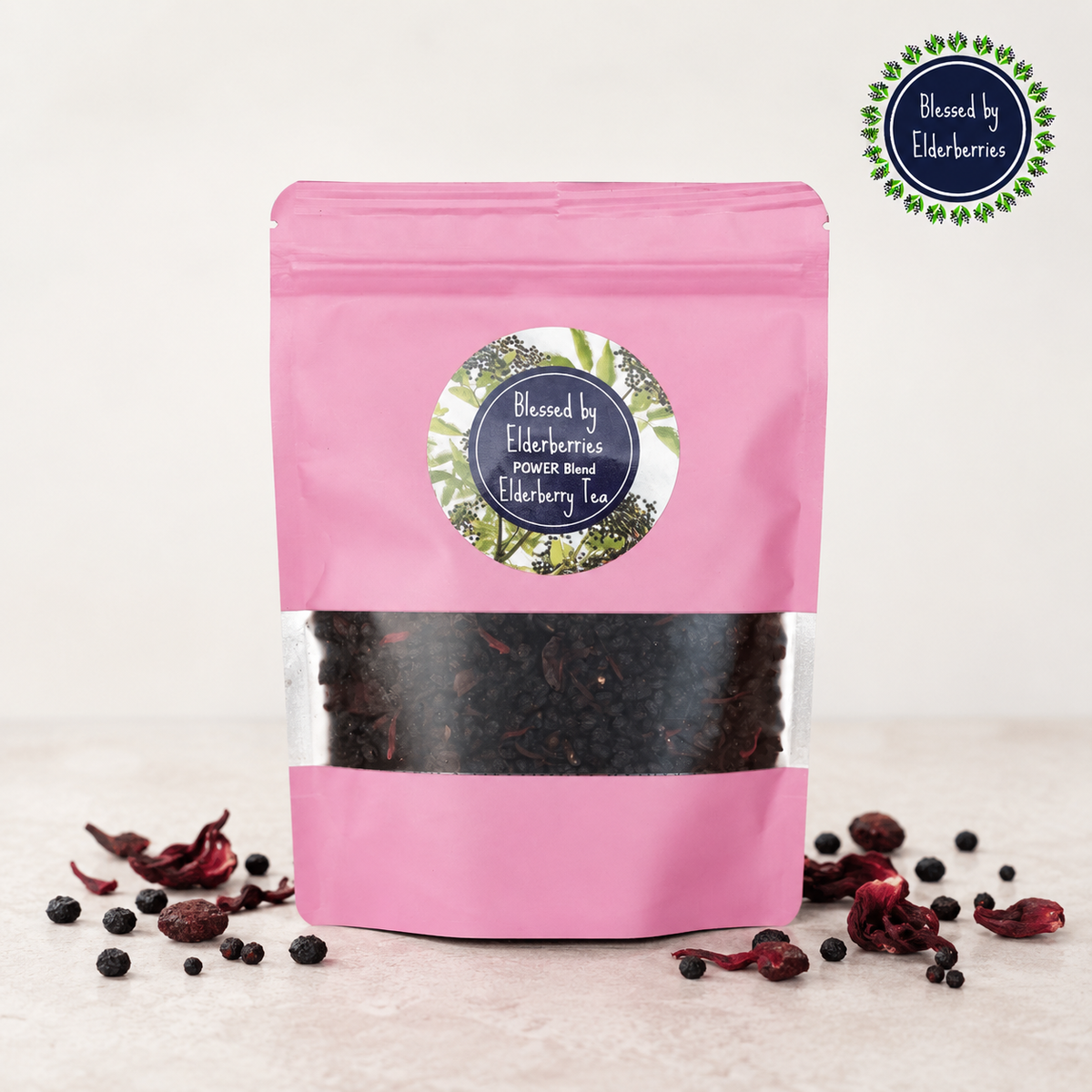 Blessed by Elderberries Power Blend Elderberry Tea in a cup with tea leaves and elderberries, showcasing a natural tea infusion.
