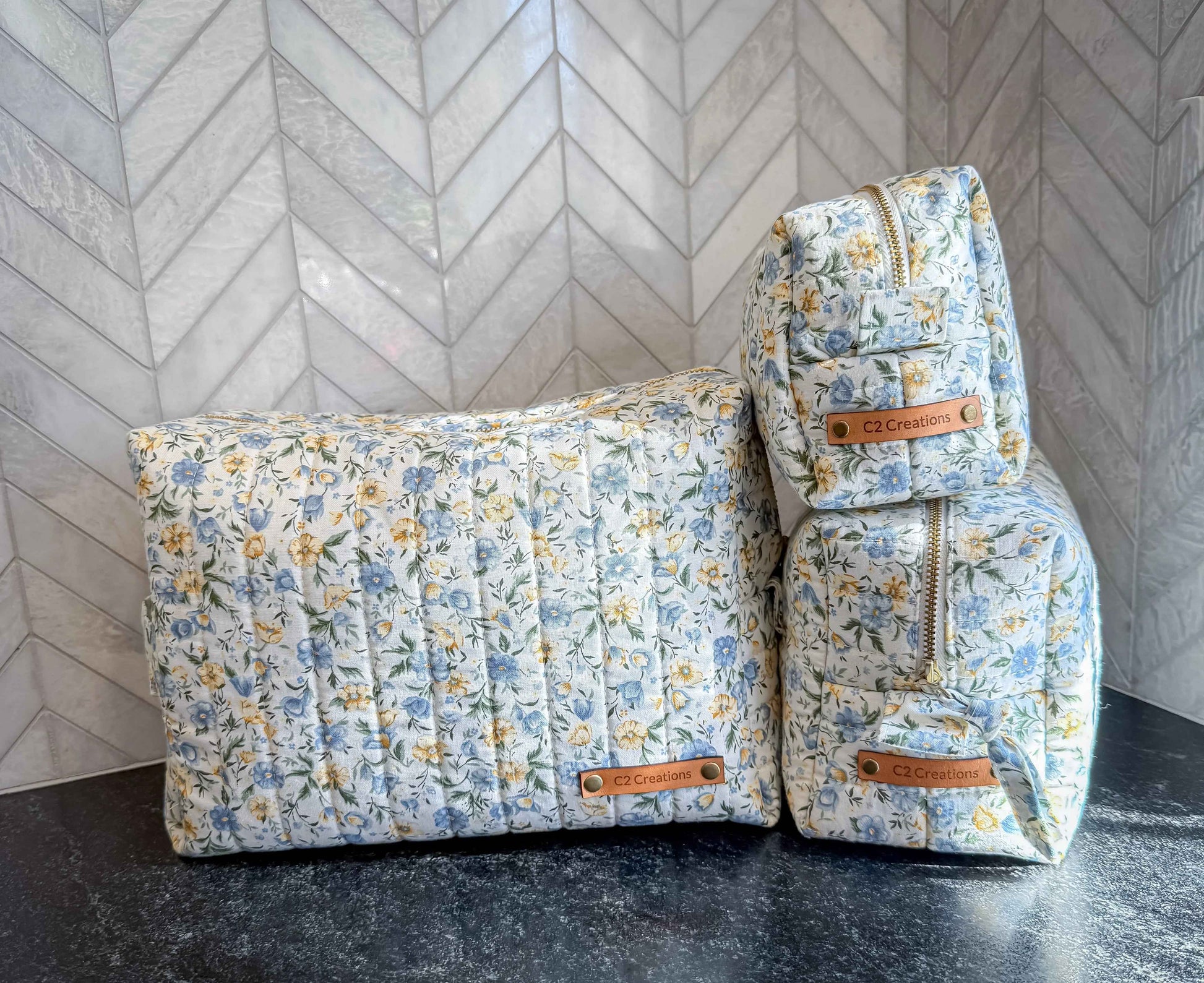 Handmade floral makeup bag with blue and yellow garden pattern, C2 Creations LLC toiletry storage bag, fabric with floral design.