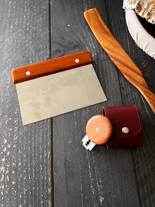 Bench scraper from Five Oaks Farm, sturdy kitchen tool with a wooden handle and stainless steel blade for baking and cooking prep.