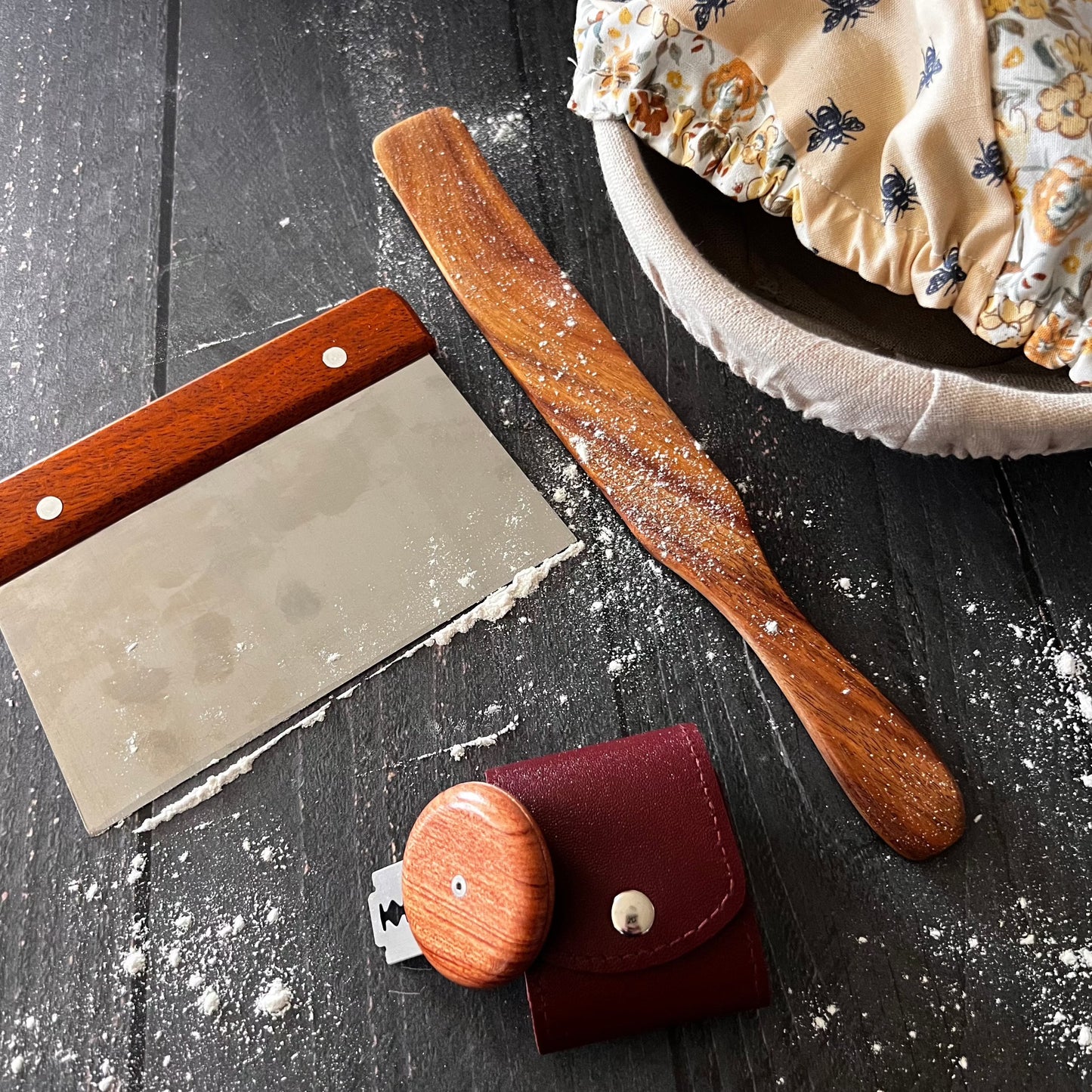 Four wooden Spurtles from Five Oaks Farm, rustic kitchen tools for cooking and stirring, arranged on a wooden surface.