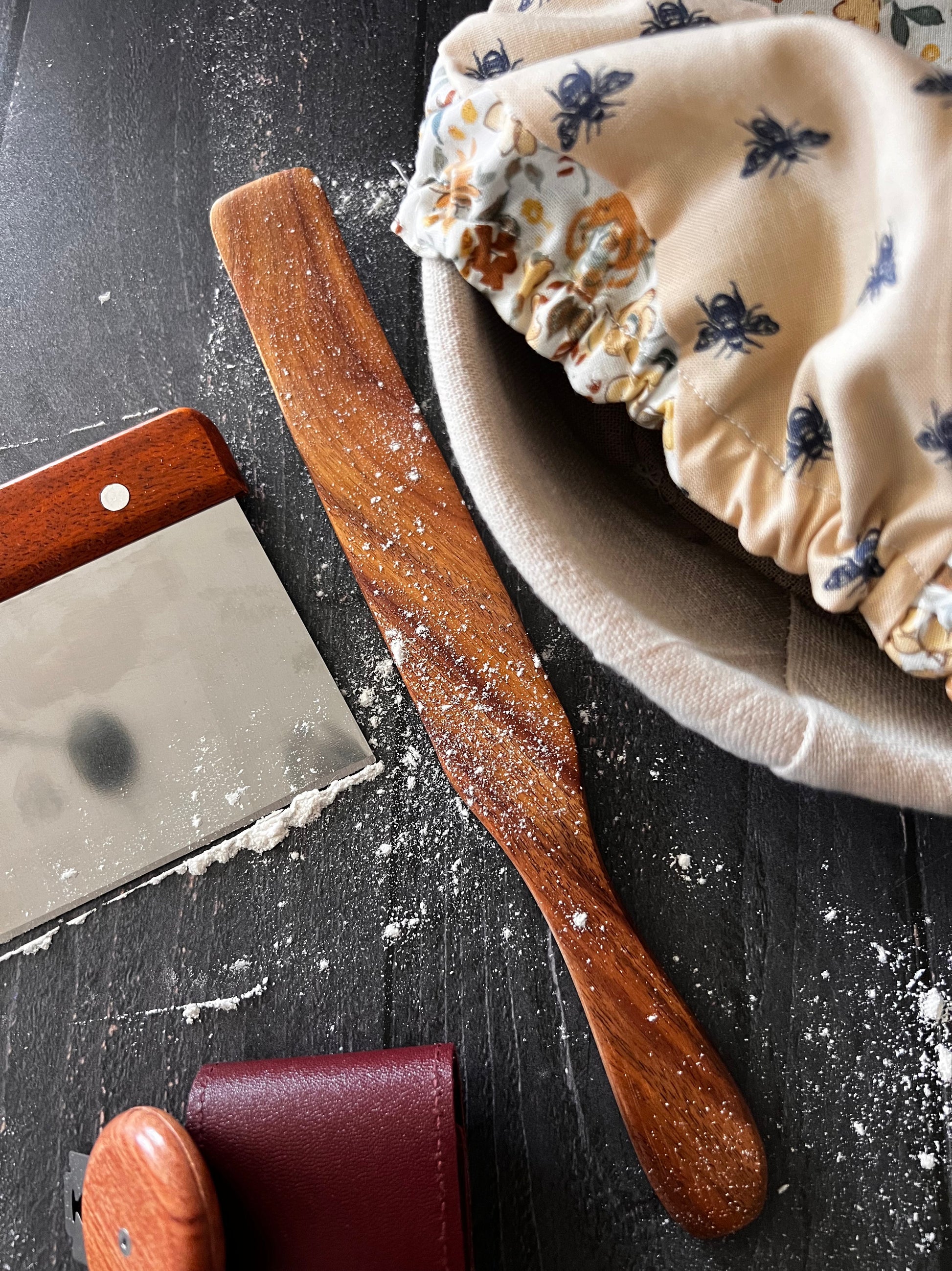 Wooden spurtle from Five Oaks Farm, showing a handcrafted kitchen utensil with a smooth, polished finish and natural wood grain.