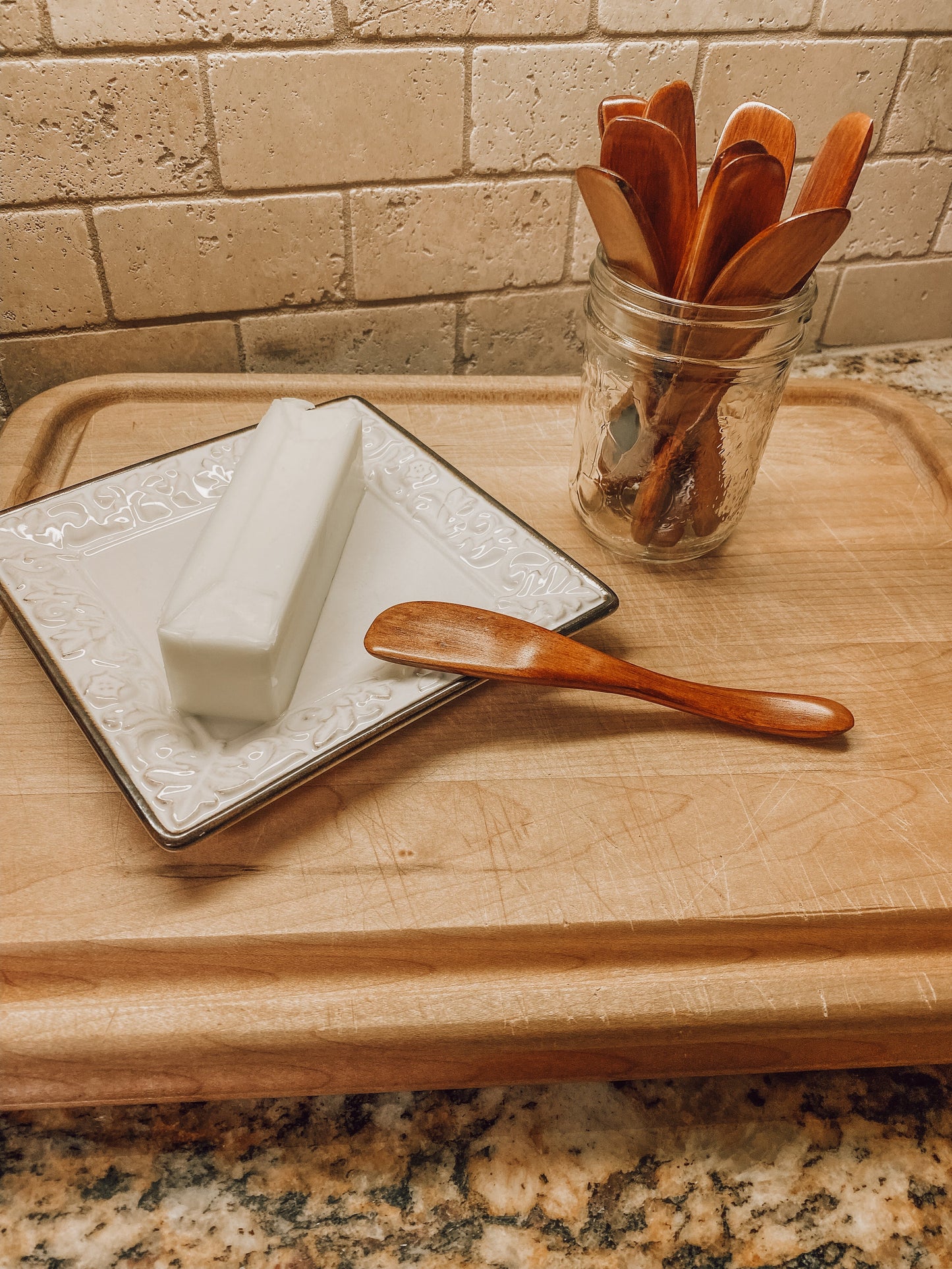 Onic Brands LLC wooden butter knife with smooth handle and rounded tip, designed for spreading butter and soft spreads.