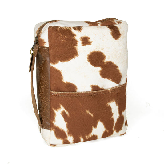 Rebekah Scott Designs longhorn cowhide Bible cover with rustic leather detailing on a wooden background.