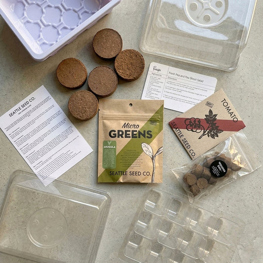 Microgreens and seed-starting kit from Seattle Seed Company with trays, soil, and microgreens growing indoors.