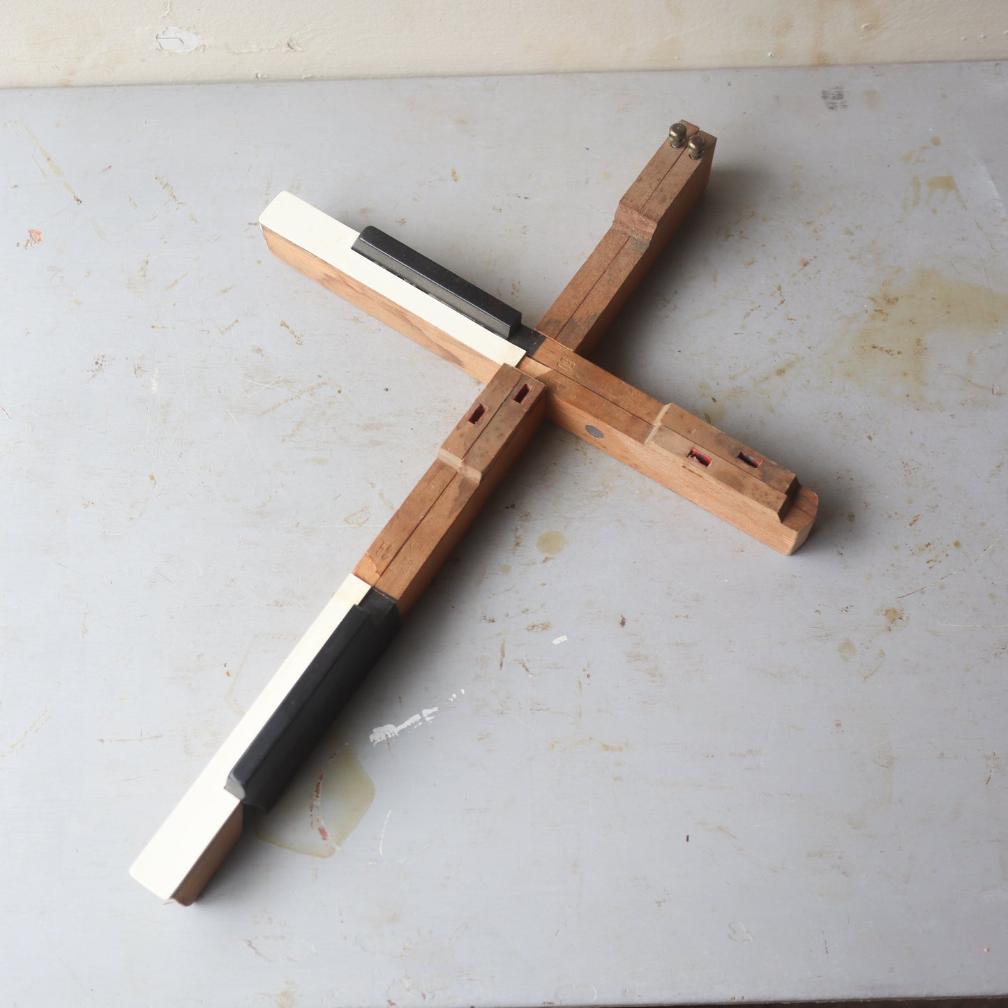 Wooden piano key cross by Dennehey Design Co., featuring detailed craftsmanship and natural wood finish.