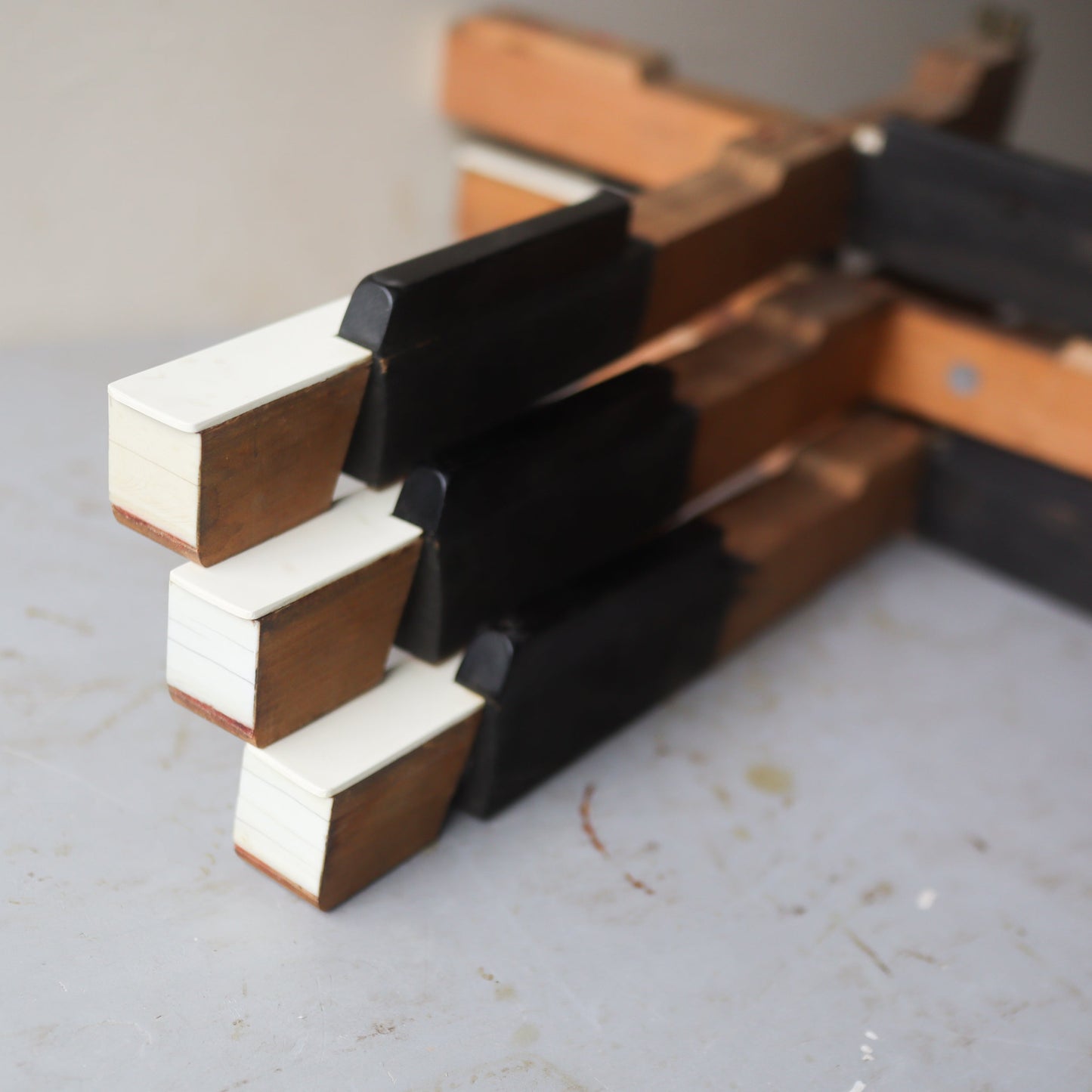 Wooden piano key cross by Dennehey Design Co., featuring detailed craftsmanship and natural wood finish.