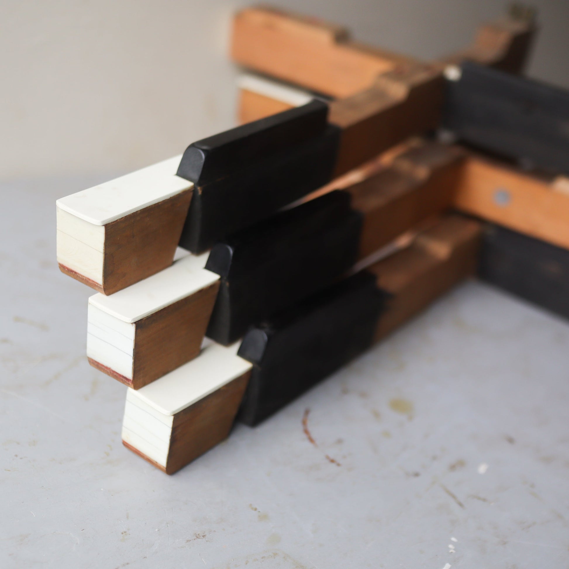 Wooden piano key cross by Dennehey Design Co., featuring detailed craftsmanship and natural wood finish.