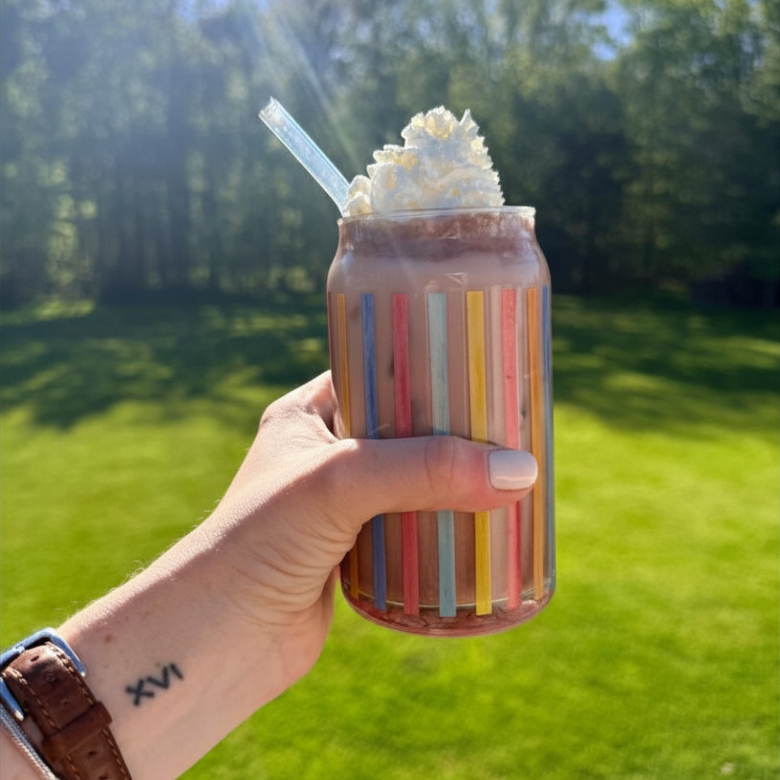 Iced salted caramel cocoa drink from Fireside Coffee Co. with whipped cream and caramel drizzle in a clear glass.