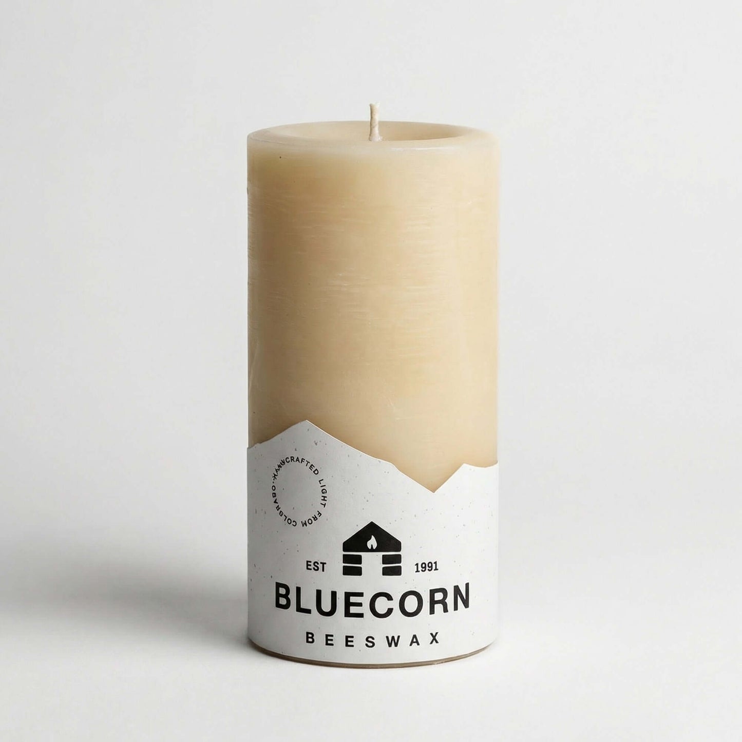 Three ivory pure beeswax pillar candles by Bluecorn Candles, 3x6 inches, with textured beeswax surface and natural organic appearance.