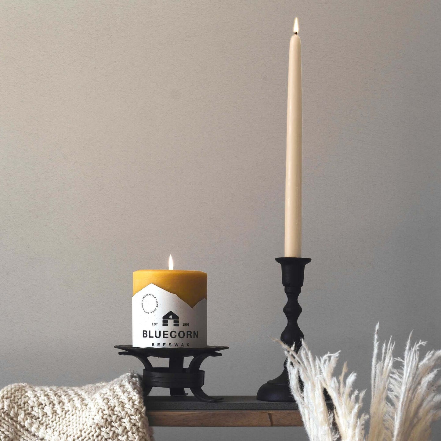 Pair of ivory Bluecorn Candles hand-dipped beeswax taper candles with blue beeswax pillars, natural and artisanal.