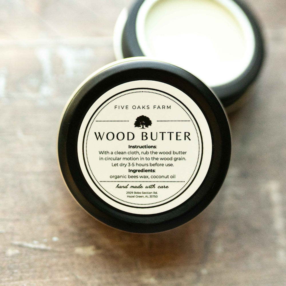 Natural wood butter from Five Oaks Farm, showing a jar of nourishing wood conditioner with a rustic label on a wooden surface.