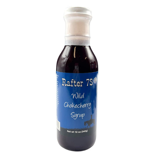 Wild chokecherry syrup in a 12 oz jar from Rafter 7S, showcasing the dark, rich color of this natural food product.