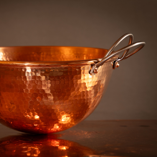Set of three copper mixing bowls by Sertodo, shiny and polished, stacked together for baking and cooking prep.