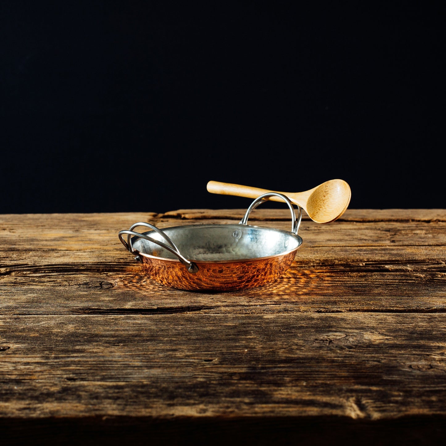 Sertodo Alicante Copper Paella Pan with a ladle, traditional round pot for cooking authentic Spanish paella, made of polished copper.