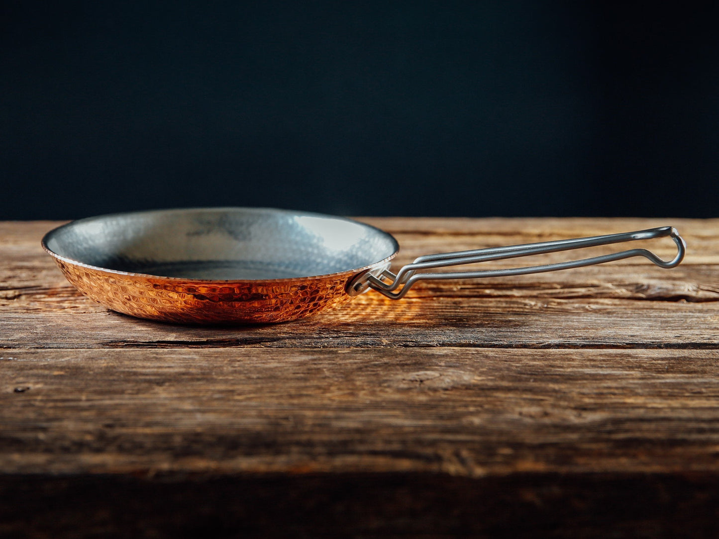 Sertodo copper skillet from pots and pans collection, showing a shiny, round copper pan with a handle on a kitchen surface.