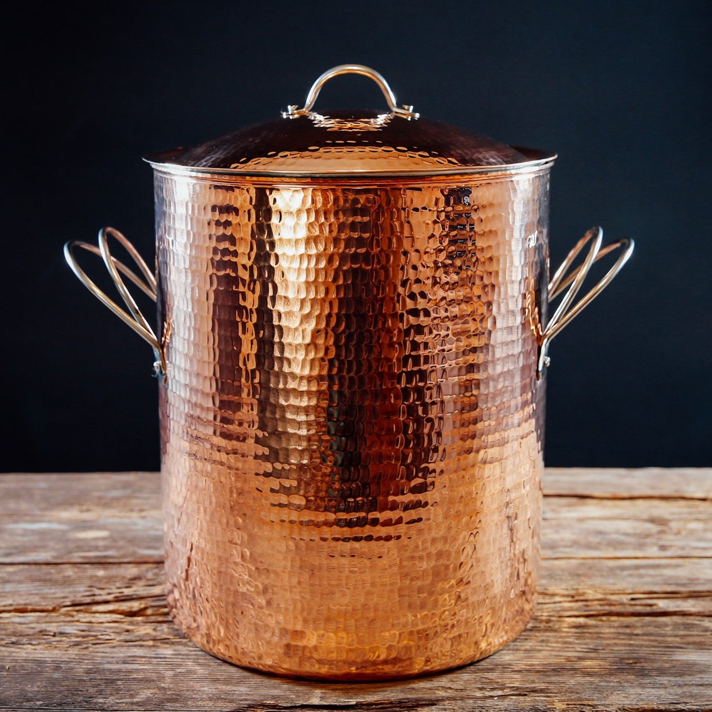 Large copper stock pot from Sertodo, showcasing shiny, round cookware with two sturdy handles for professional kitchen use.