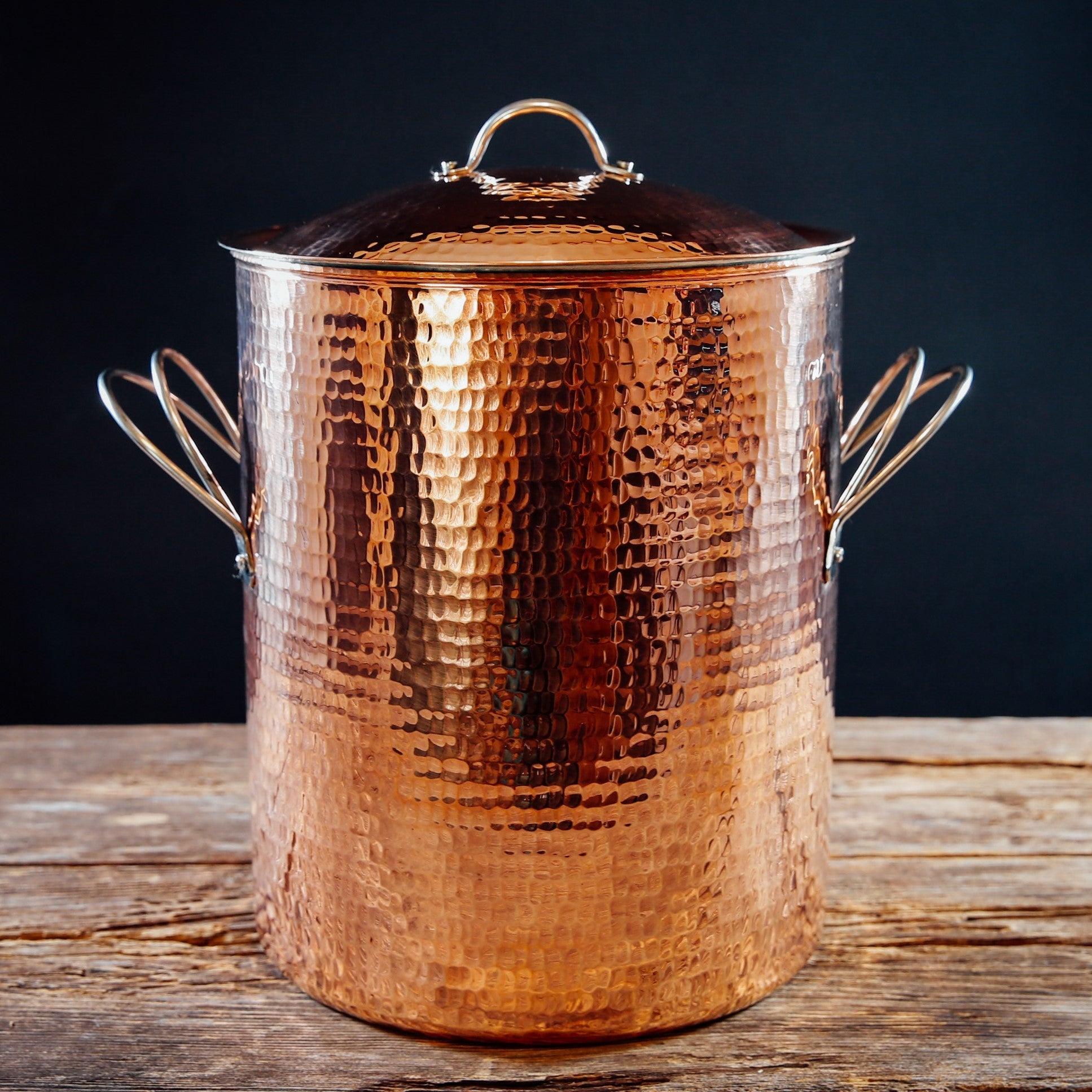 Large copper stock pot from Sertodo, showcasing shiny, round cookware with two sturdy handles for professional kitchen use.