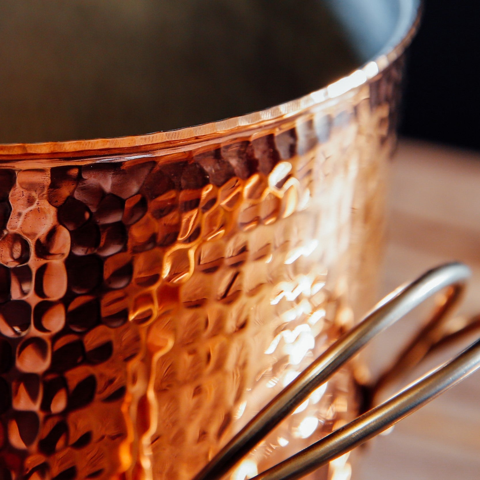 Close-up of Sertodo copper stock pot showing its polished edge and craftsmanship, part of the cookware collection.