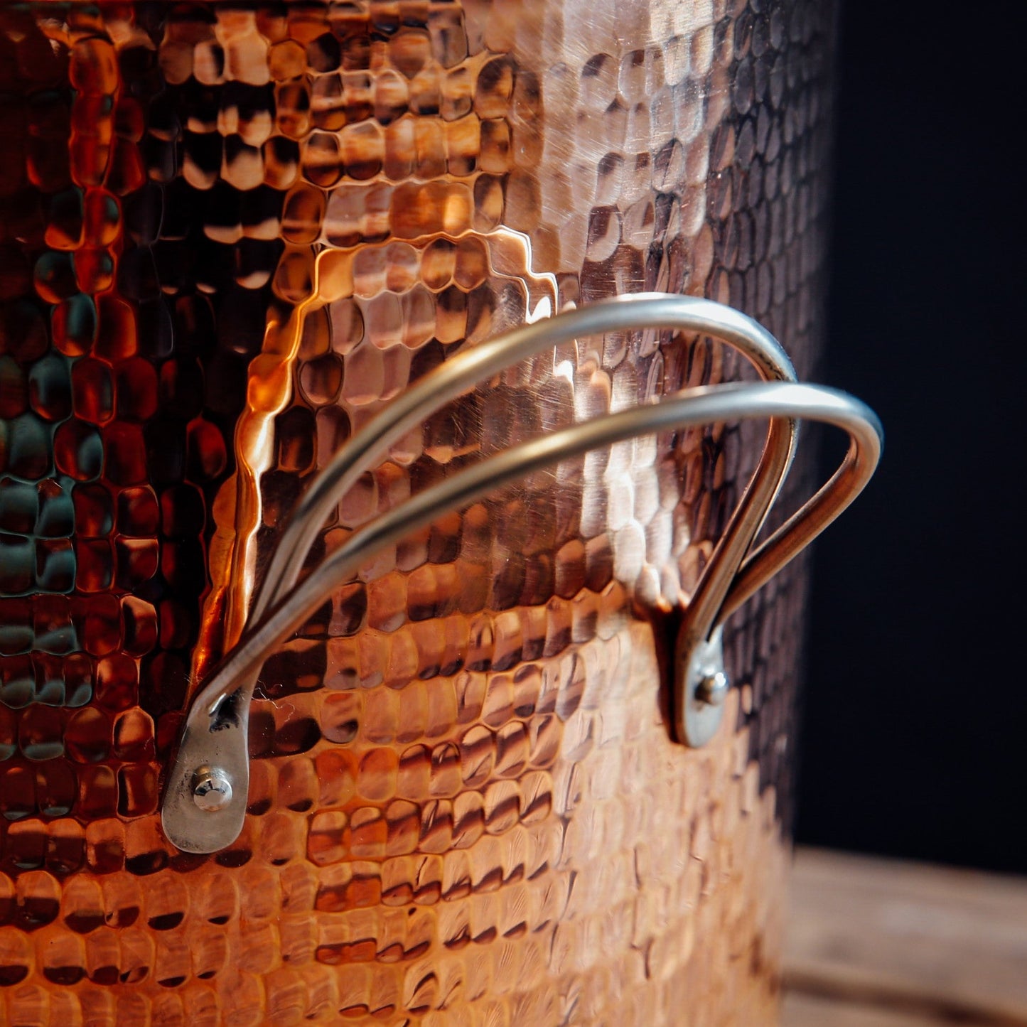 Side view of Sertodo copper stock pot with sturdy handle, showcasing its polished, durable copper surface for professional cooking.