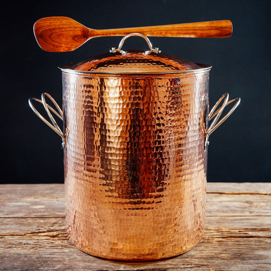 Large copper stock pot from Sertodo with a lid and spoon for versatile cooking and serving in the kitchen.