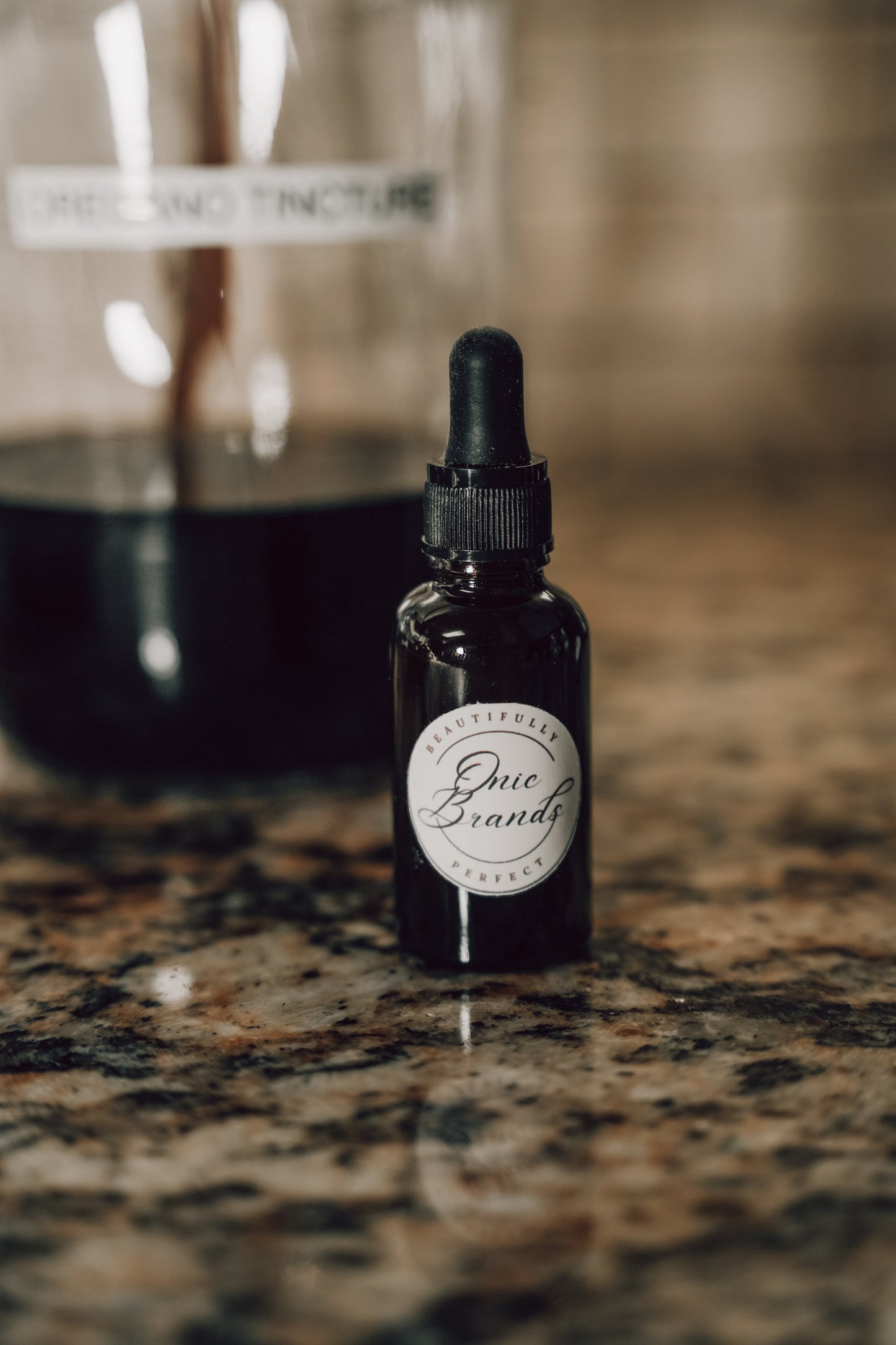 Onic Brands Elemental Oregano tincture bottle with dropper cap, herbal supplement for wellness, on a white background.