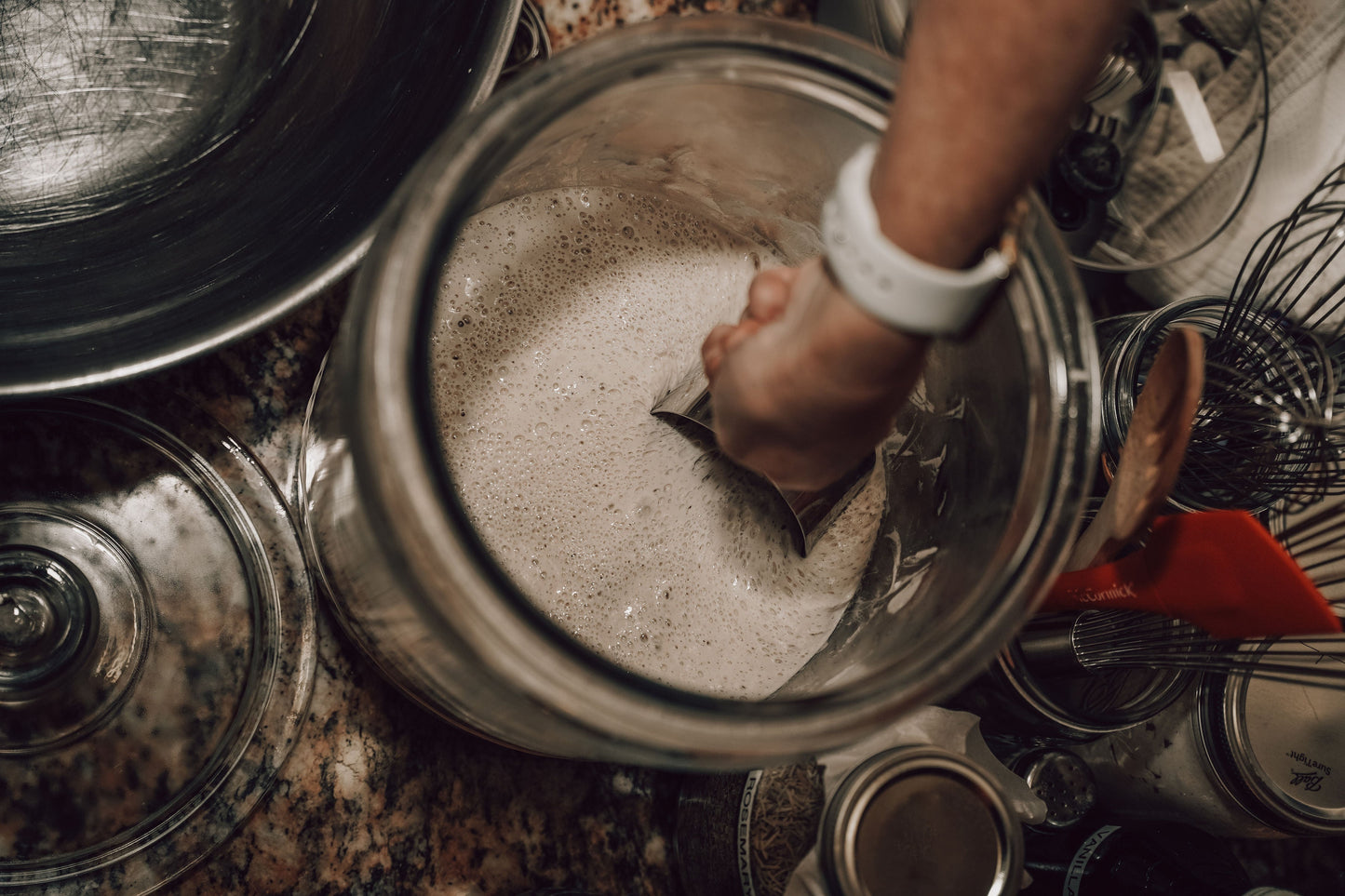 Onic Brands LLC sourdough starter in a glass jar with a bubbly, active fermentation mixture ready for baking.