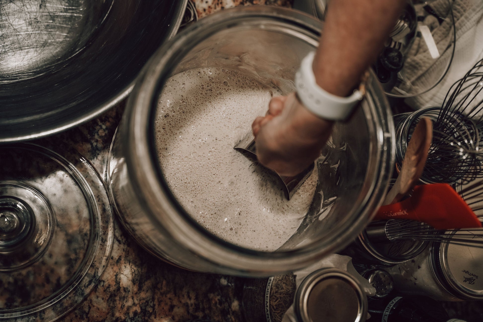 Onic Brands LLC sourdough starter in a glass jar with a bubbly, active fermentation mixture ready for baking.