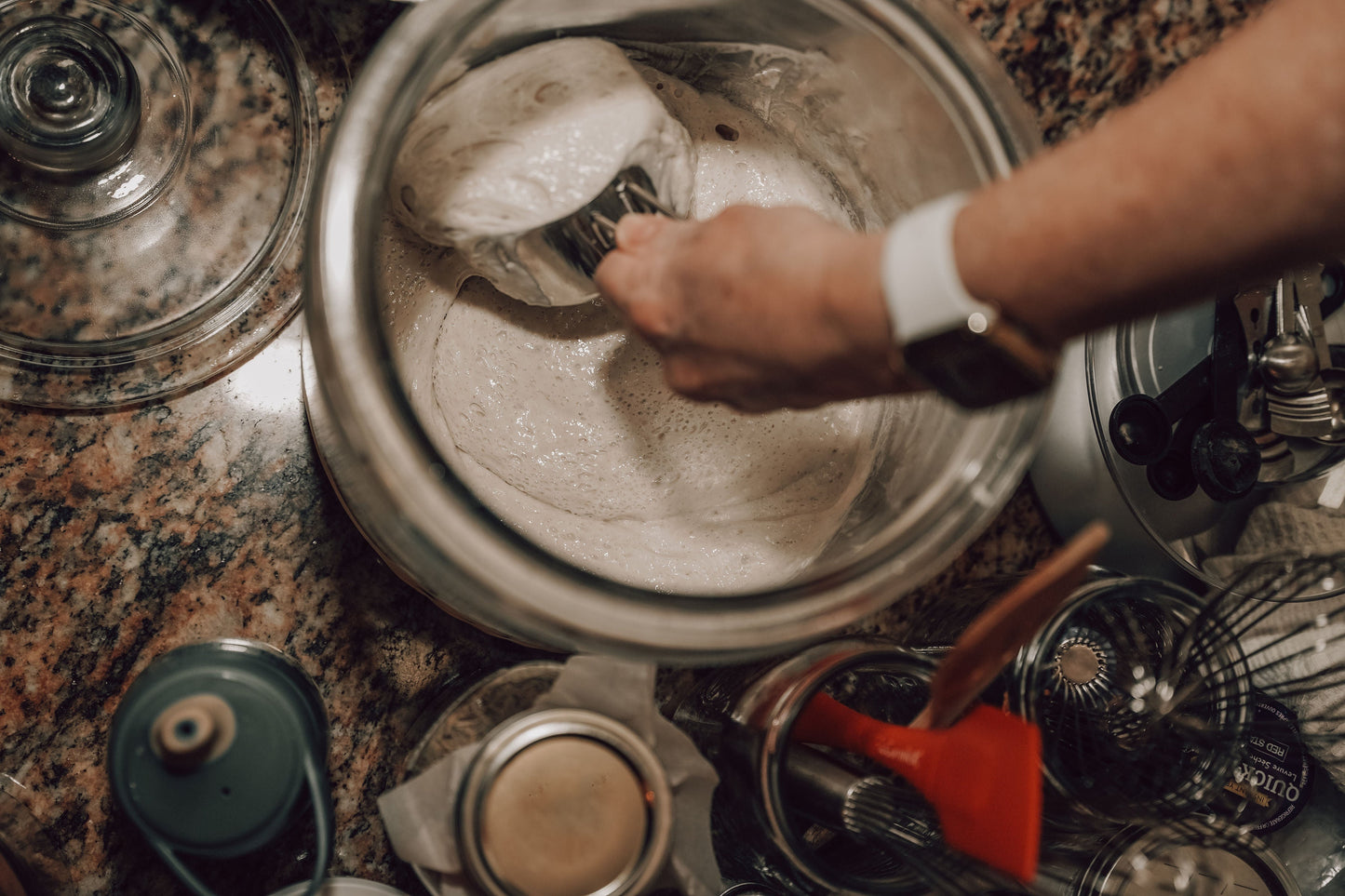 Onic Brands LLC sourdough starter in a glass jar with a bubbly, active fermentation culture ready for baking bread.