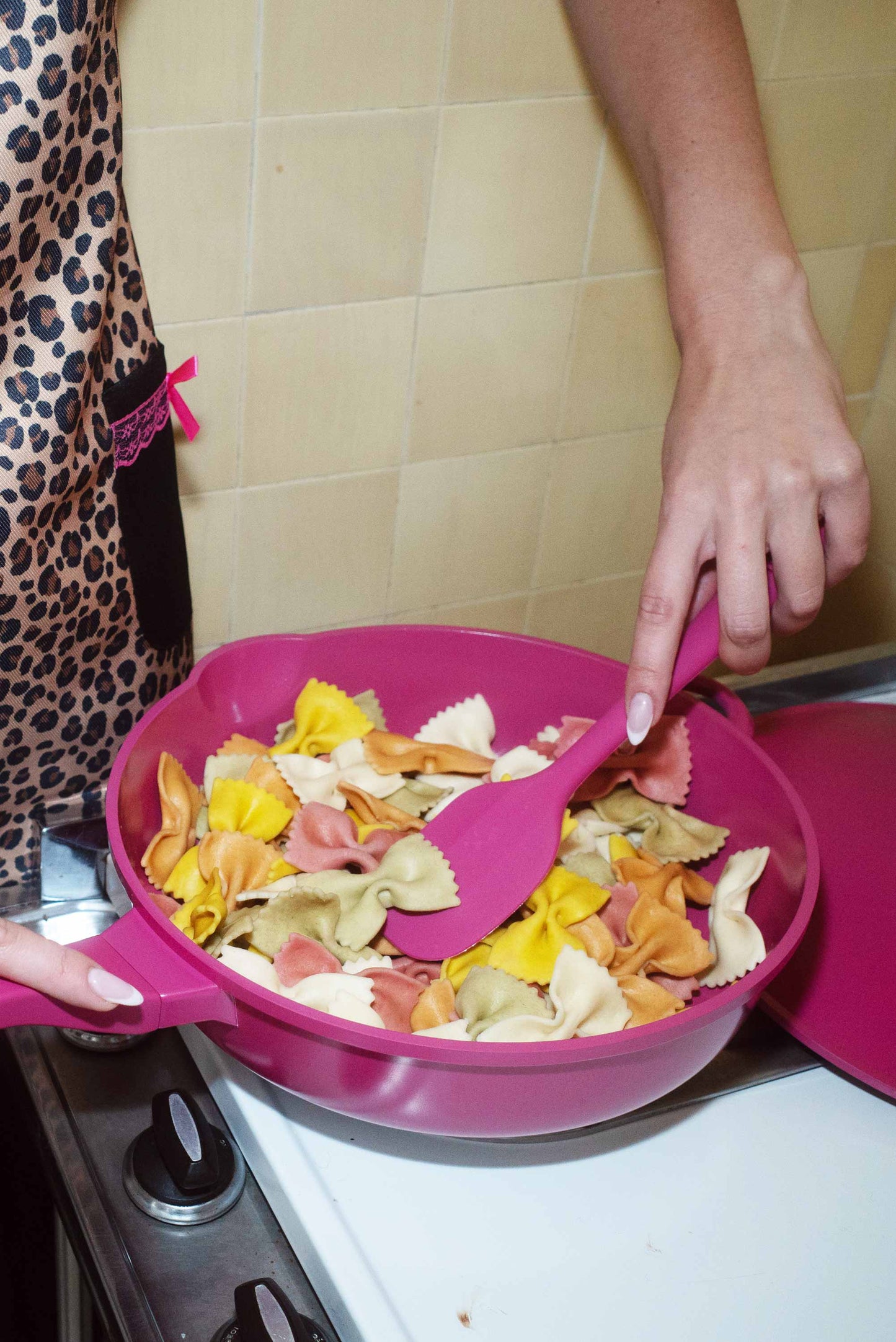 Lynnee leopard apron in hot pink with bold leopard print, made of durable fabric, perfect for cooking and kitchen protection.