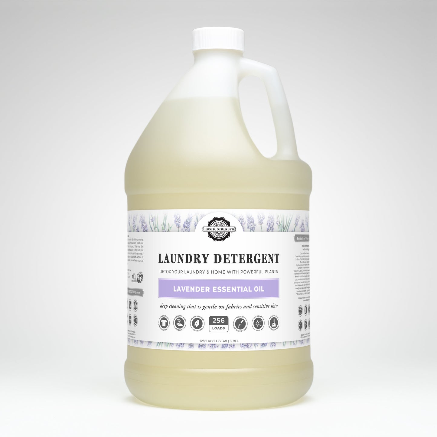 A large, clear plastic jug of Rustic Strength Laundry Detergent | Lavender features a white cap and handle. The label shows lavender graphics, eco-friendly icons, and notes its hypoallergenic with lavender essential oil.