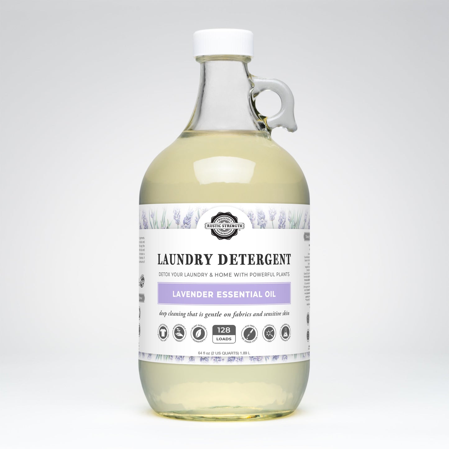 Rustic Strength Laundry Detergent | Lavender comes in a clear glass bottle with a white cap and handle, labeled with lavender art. It’s hypoallergenic, plant-based, biodegradable, and gentle—enough for 128 loads.