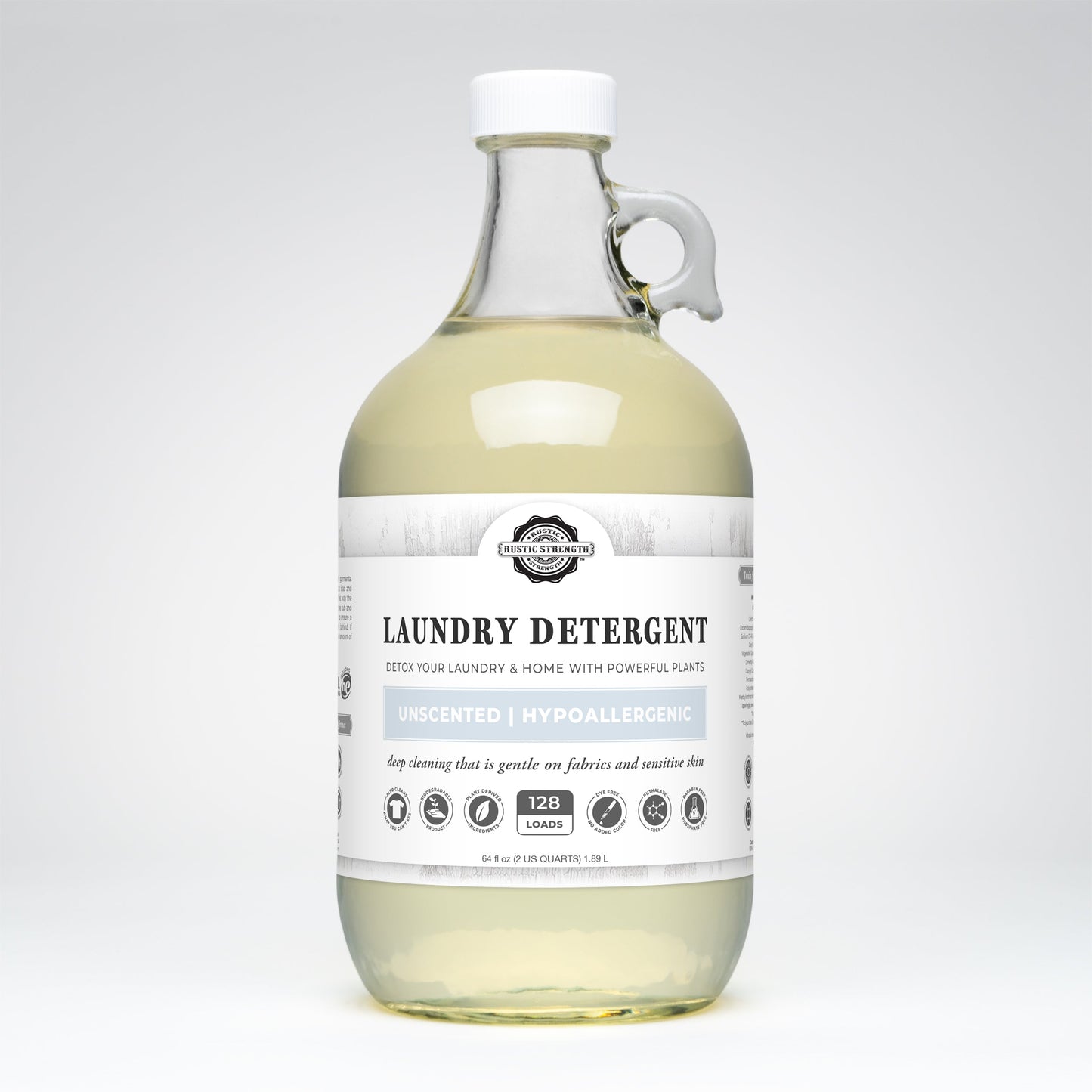 Rustic Strength Laundry Detergent | Unscented comes in a clear glass bottle with a white cap and handle, provides 128 loads, and features a plant-based, biodegradable, hypoallergenic formula suitable for sensitive skin.