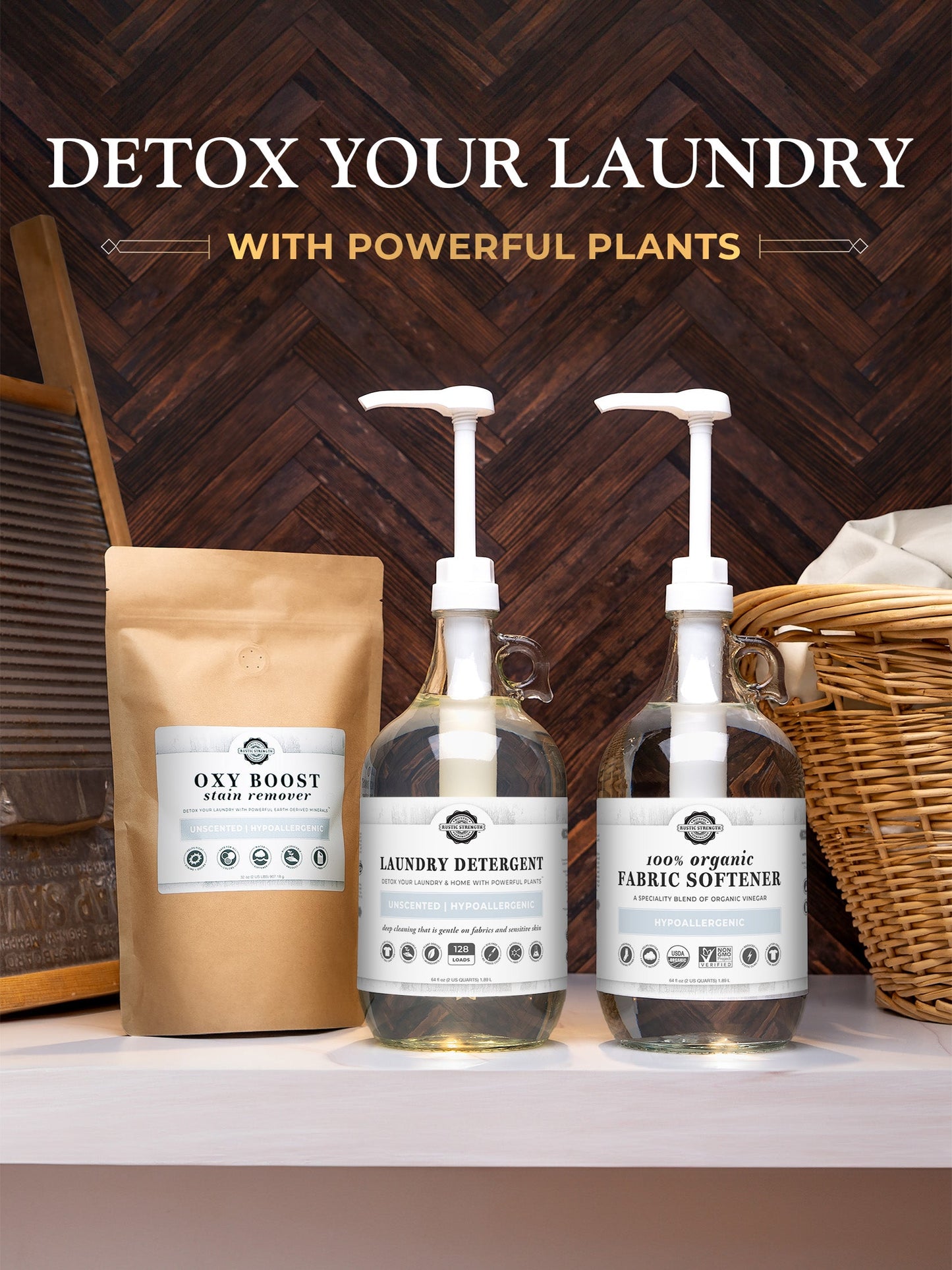 Rustic Strength Laundry Detergent | Unscented in a glass pump bottle sits with an organic fabric softener and Oxy Boost stain remover pouch on a wooden surface, surrounded by laundry props.