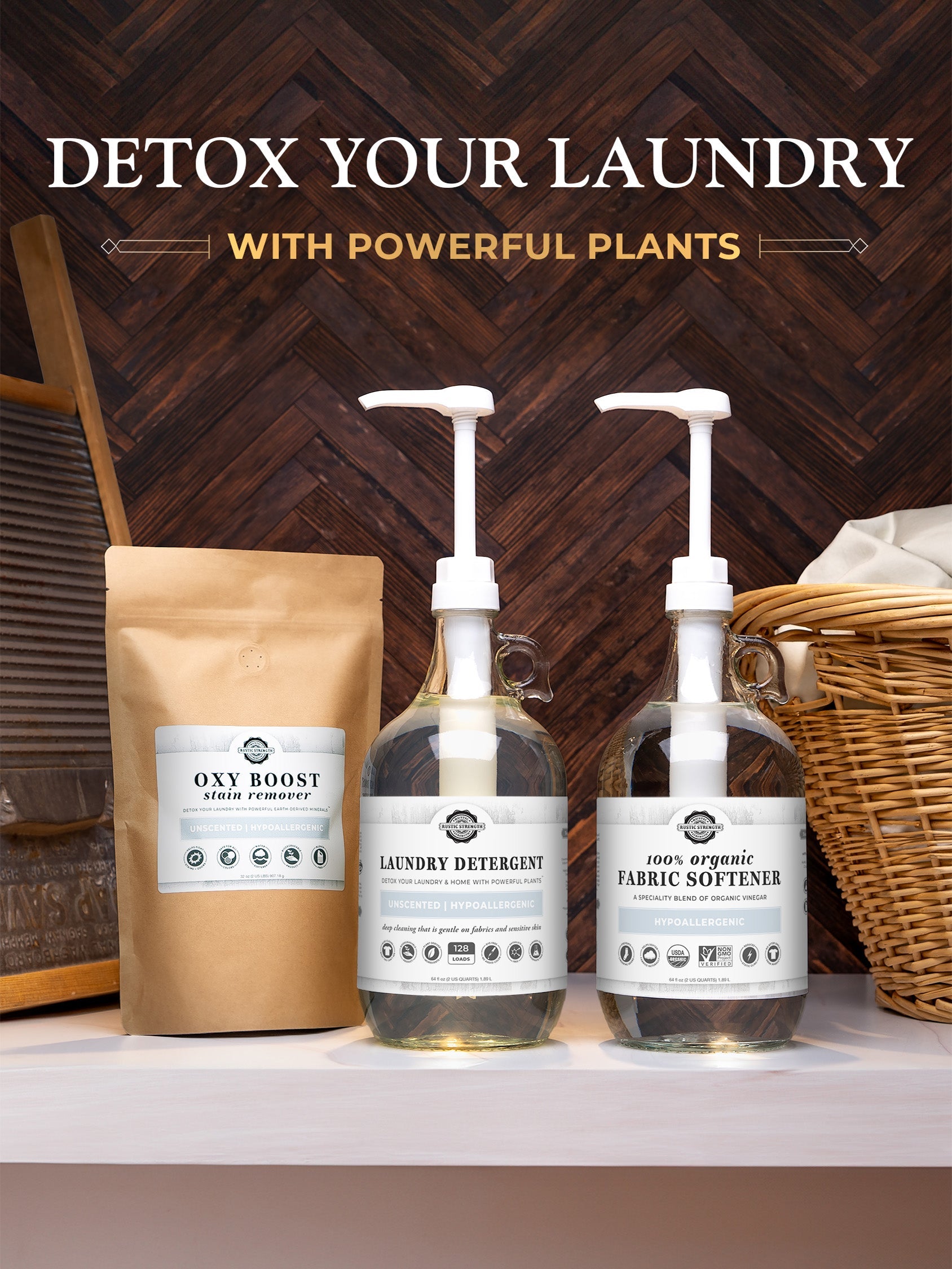 Rustic Strength Laundry Detergent | Unscented in a glass pump bottle sits with an organic fabric softener and Oxy Boost stain remover pouch on a wooden surface, surrounded by laundry props.