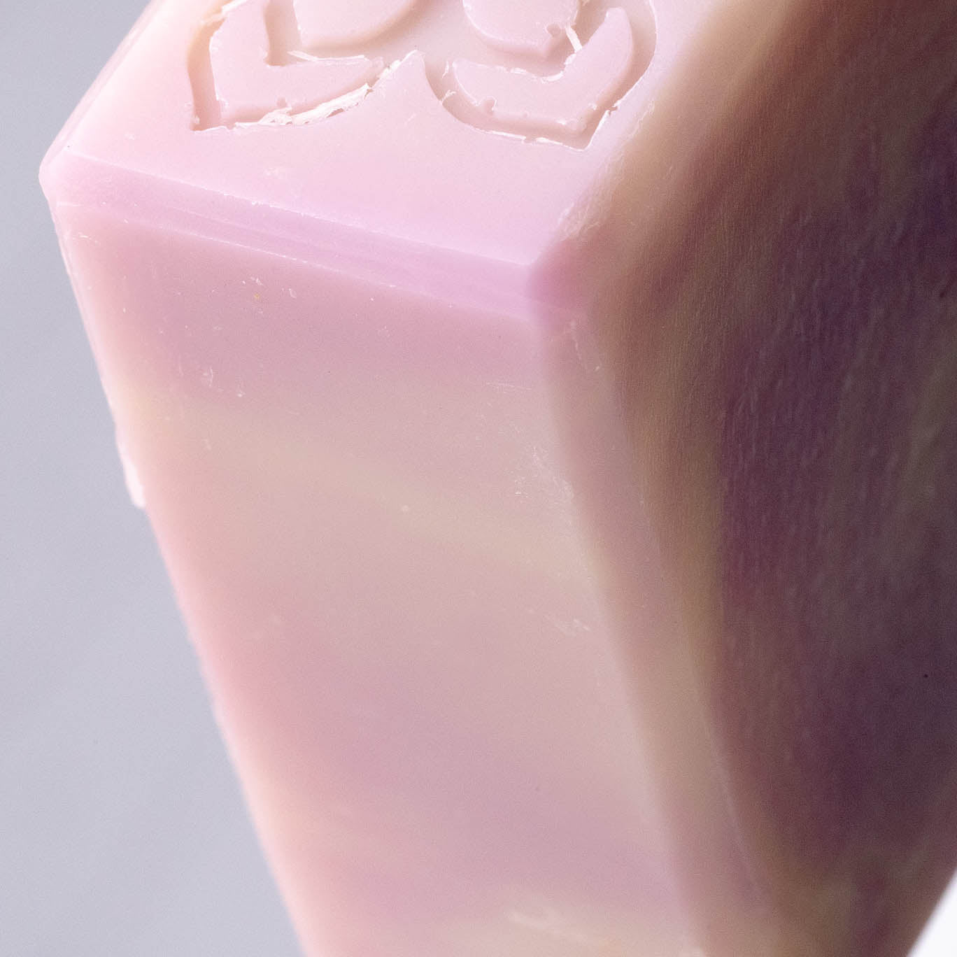 Close-up of Rustic Strength’s Bar Soap | Lavender, featuring a pink and cream marbled design with an embossed top edge; crafted for sensitive skin.