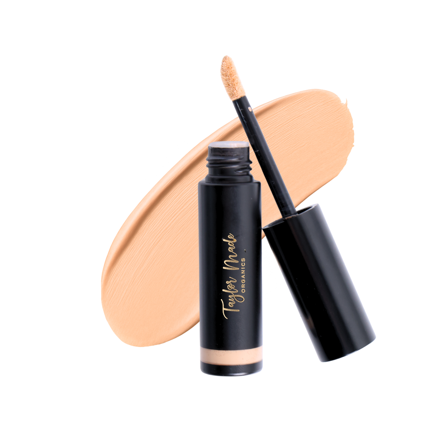 Liquid organic concealer by Taylor Made Organics, showing a smudged linen-colored concealer on a clean surface.