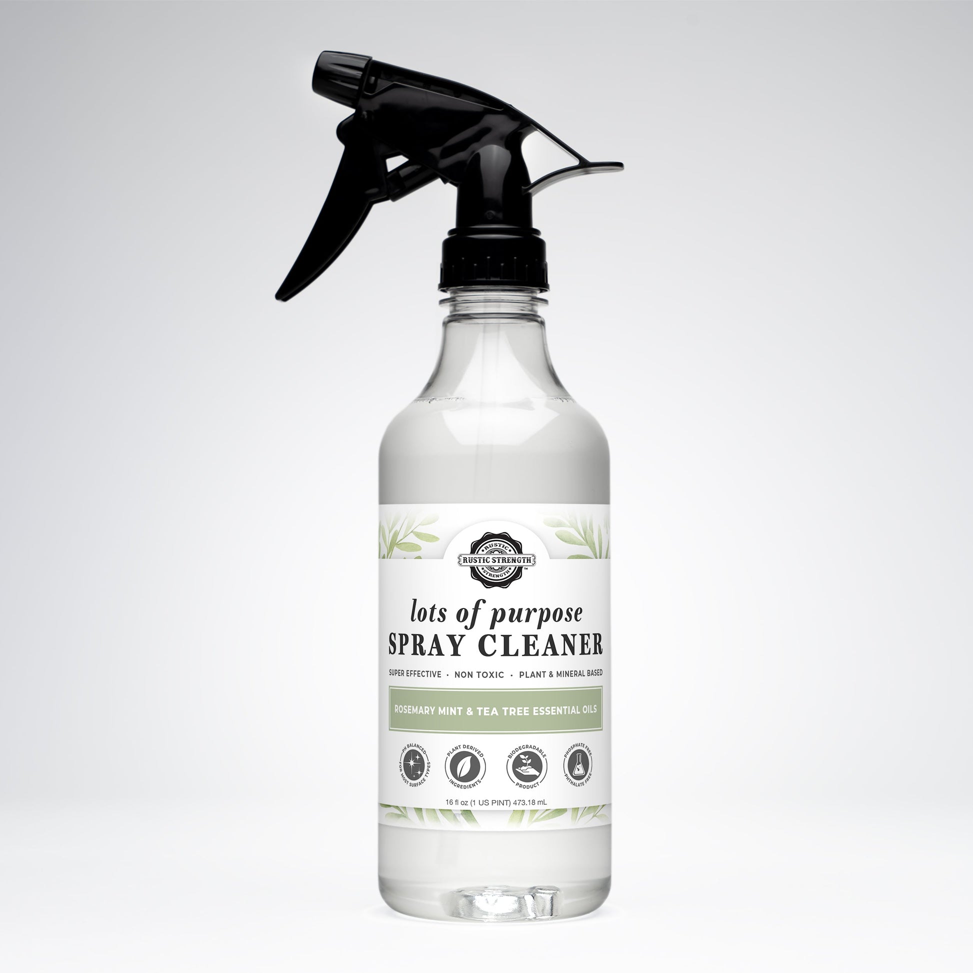 A clear spray bottle of Rustic Strength’s Lots of Purpose Spray Cleaner | Rosemary, Mint & Tea Tree, with a black trigger nozzle and a label featuring natural, plant-based ingredients, sits on a plain white background.