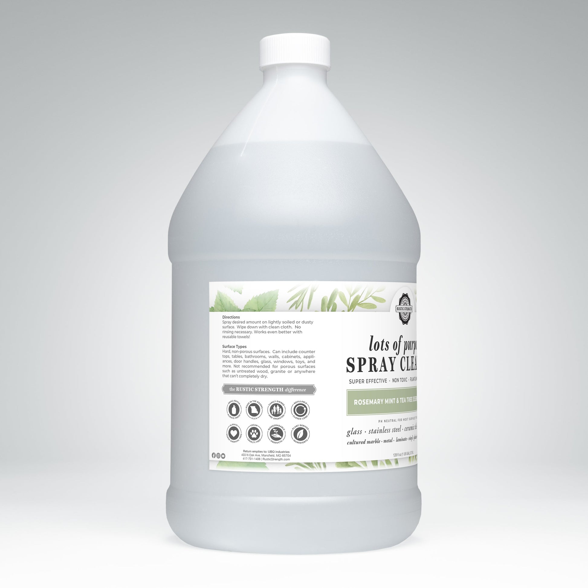 A large clear plastic gallon bottle with a white cap, labeled Rustic Strength Lots of Purpose Spray Cleaner | Rosemary, Mint & Tea Tree; the label features usage directions, warnings, and decorative green leaf illustrations.