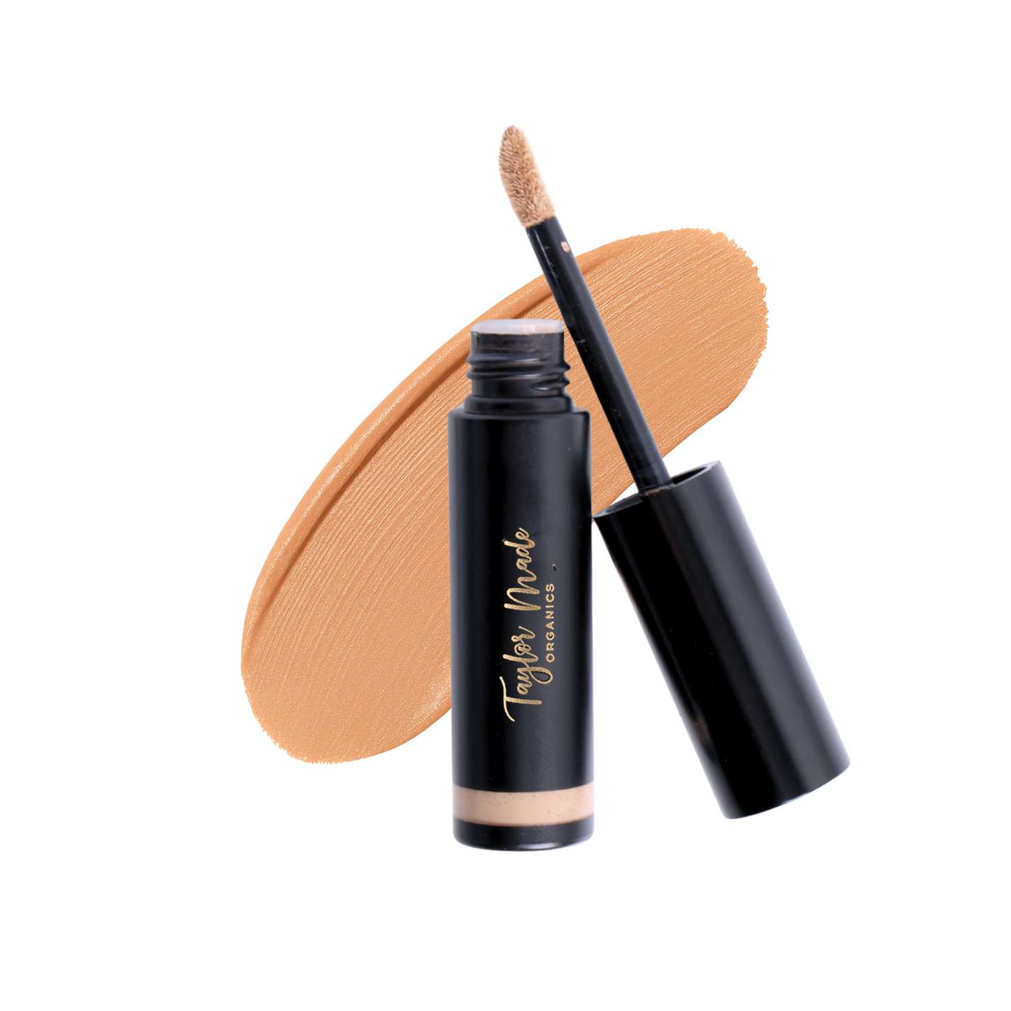 Swatch of Taylor Made Organics Liquid Organic Concealer in maple shade showing smooth, creamy texture on skin.