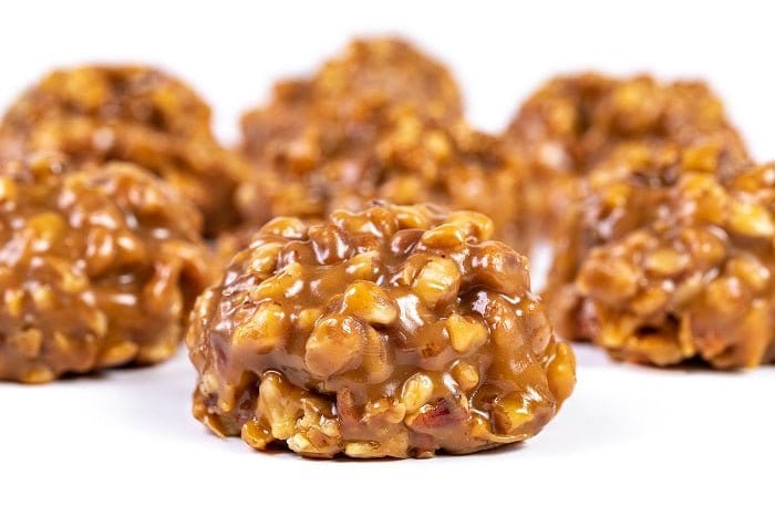 Chewy pecan pralines from Millican Pecan, individual pecan treat with caramelized coating and crunchy pecan pieces.