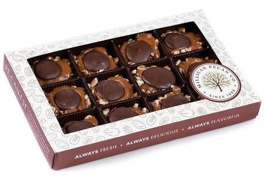 Dark chocolate Caramillicans pecan treats in an 8oz gift box by Millican Pecan, featuring glossy chocolate coating and crunchy pecans.