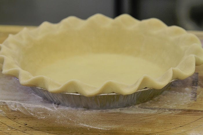 Millican Pecan Chocolate Pecan Pie with a golden crust and rich chocolate and pecan filling, ready to serve.