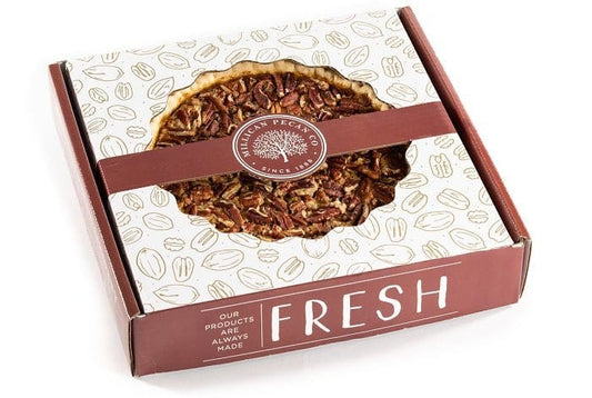 Boxed Millican Pecan Pecan Pie with golden-brown crust and glazed pecans, perfect for dessert.
