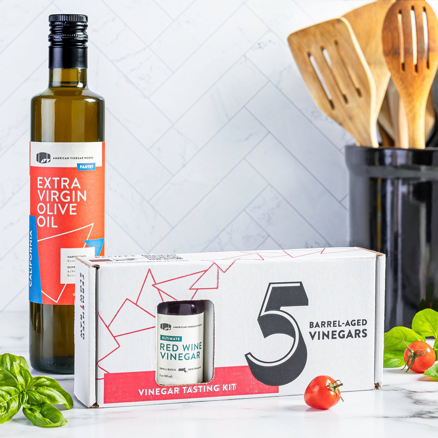 American Vinegar Works oil and vinegar sampler with small bottles of assorted vinegar varieties in a colorful display.